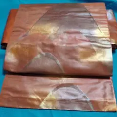 名古屋帯 オレンジ系金糸 抽象模様　六通