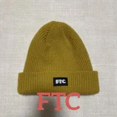[美品]FTC エフティーシー アクリルロゴビーニー マスタード ニット帽のサムネイル
