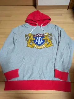 アールディーズLOVE JOKE プルオーバー グレー/レッド