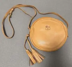 IL BISONTE 円形ショルダーバッグ ベージュ タッセル付き