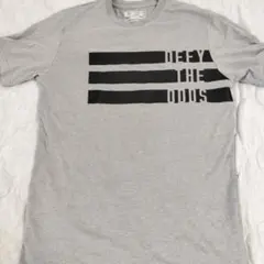 【New Balance】Tシャツ グレー DEFY THE ODDSのサムネイル