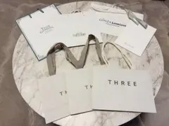 THREEの紙袋3枚とRMKを含む他ブランド4枚の紙袋計7枚セットのサムネイル