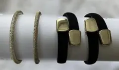 モダンデザインアームバンド2種類　黒スエードのもの1組と金属系コイル状のもの1組