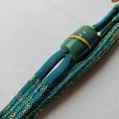 【平】未使用 帯締め 平組14ミリ 孔雀緑 金ラメ とんぼ玉 金正組紐所 光珠
