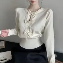 リボン付きアプリコット色長袖トップス