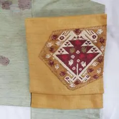 八寸名古屋帯▪正絹▪黄土色地の紬地に向かい鳥幾何学模様▪長さ350cm幅29cm