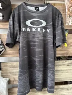 オークリー 半袖スポーツTシャツ 総柄 ダークグレー ビッグロゴ メンズLのサムネイル