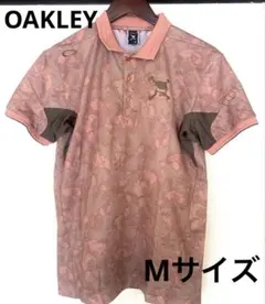 【美品】オークリー OAKLEY ポロシャツ Mサイズ 総柄 ピンク系のサムネイル