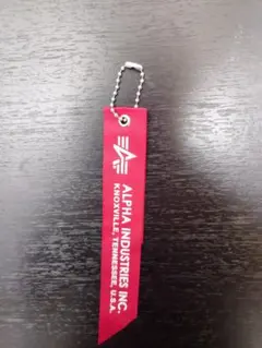 ③ ALPHA INDUSTRIES 赤リボン タグ