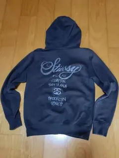 STUSSY × Champion ワールドツアー ジップアップパーカー